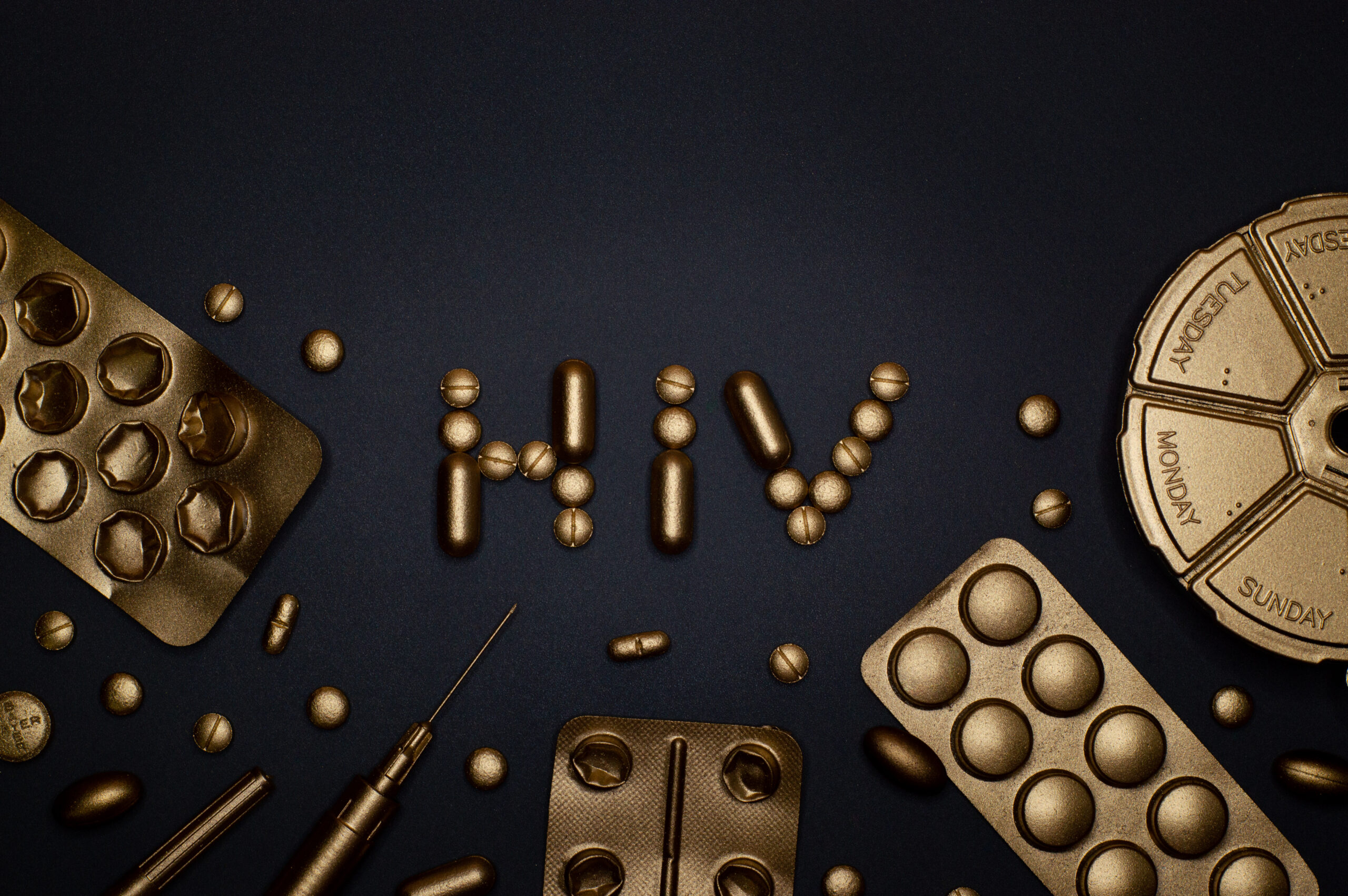 Syringe and pills on blue background